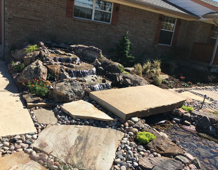 A custom water fall water feature and landscaping that we designed and built